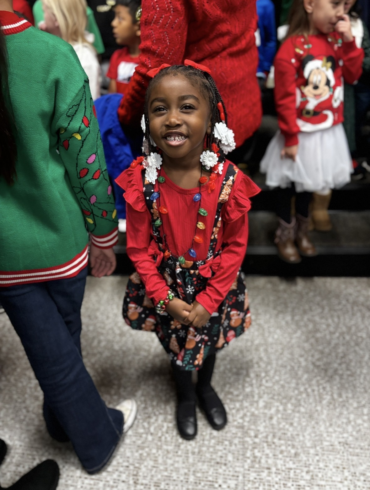 Preschooler smiling brightly at the holiday program